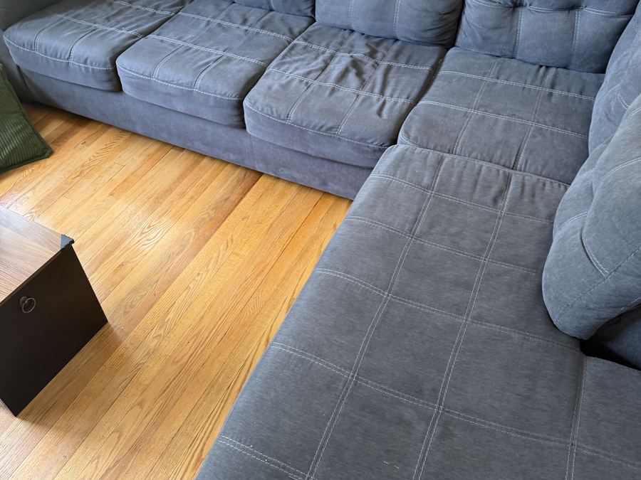 Grey quilted sectional sofa before upholstery cleaning in Passaic County NJ