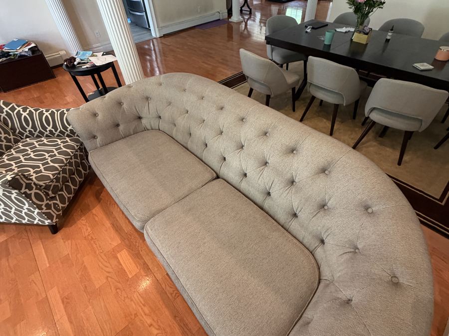 Same tufted sofa after cleaning, cushions even and fresh